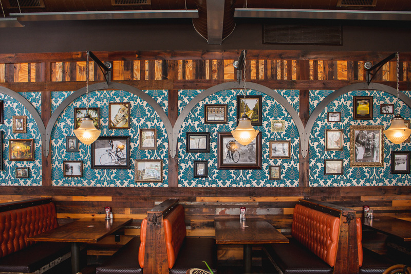 Blue wallpaper and orange booths at Café Hollander Hilldale