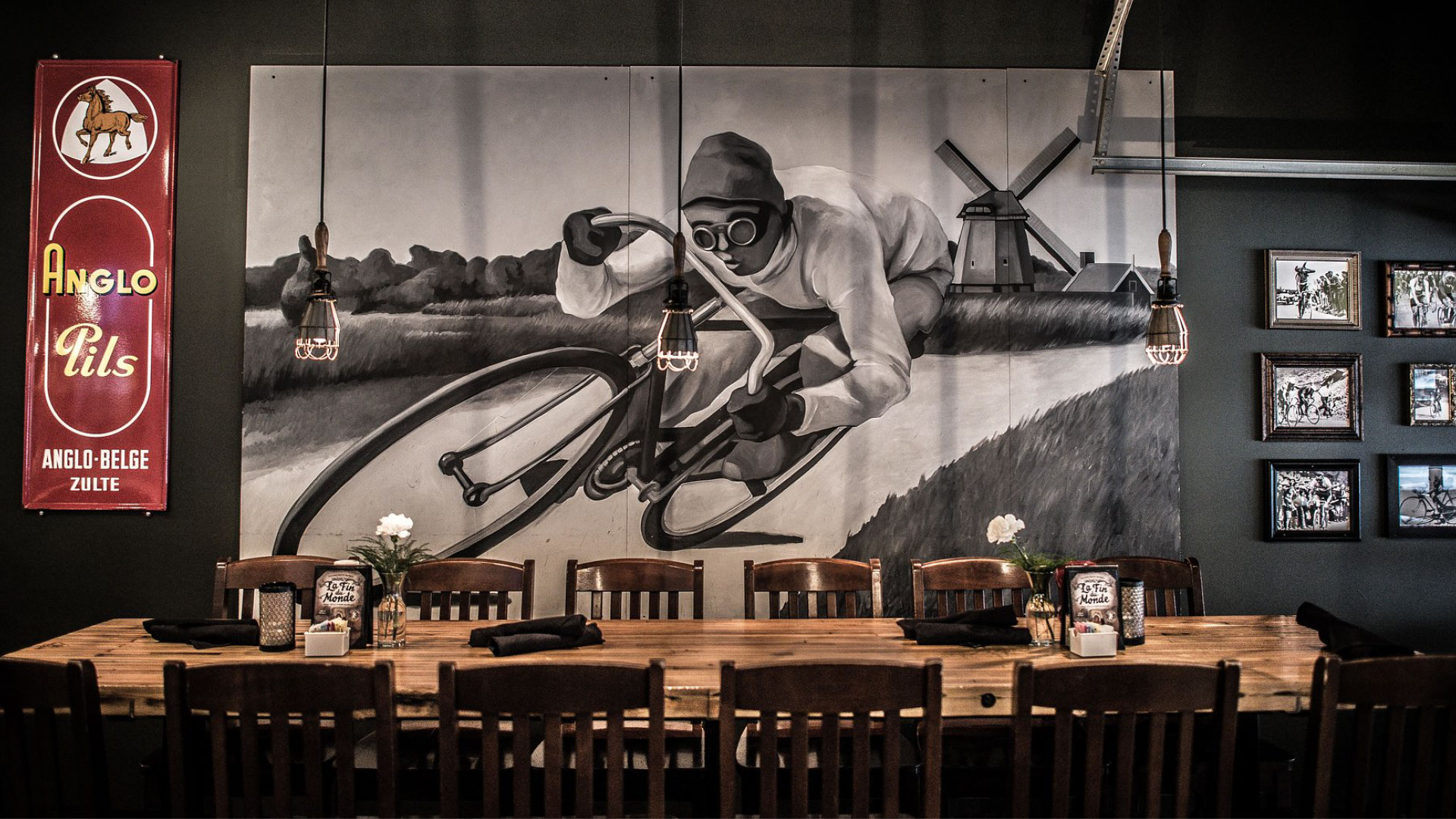 A large painting of a bike racer on the wall at Café Benelux